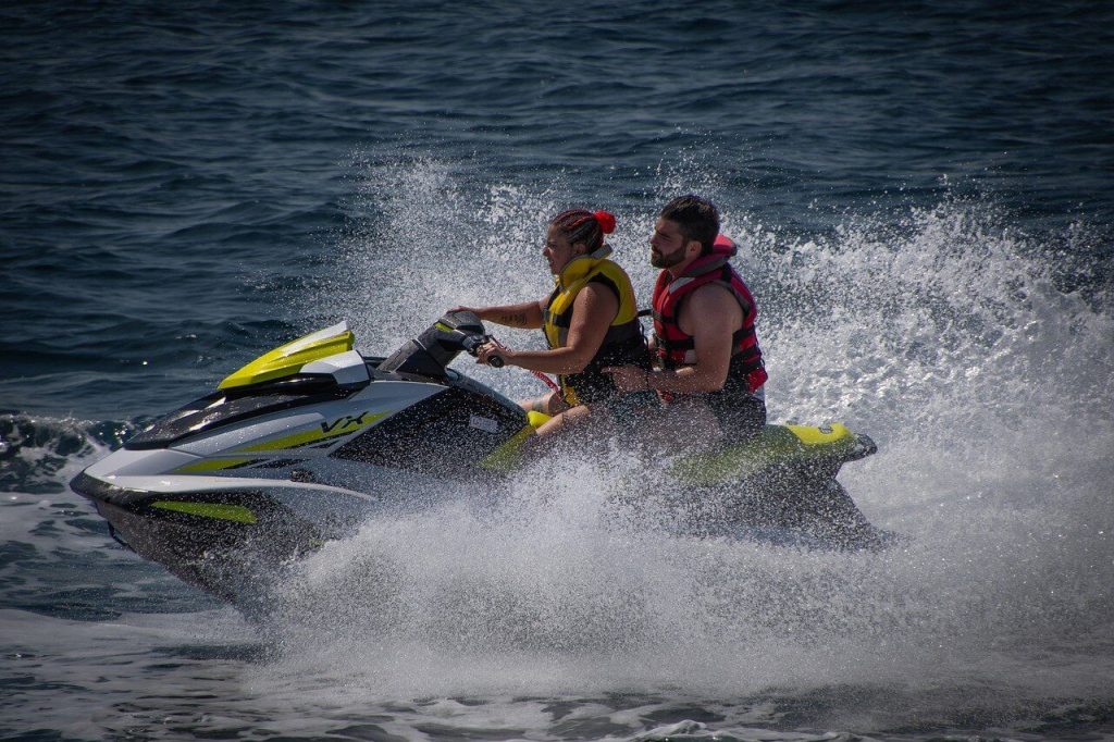 a couple riding a jet ski together