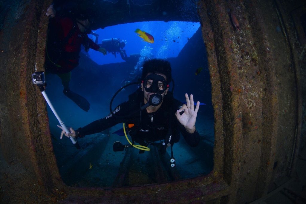 a scuba diver passing a door